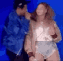 a blurry picture of a man and a woman dancing on stage .