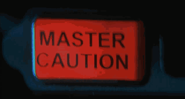 a red sign that says master caution in black letters