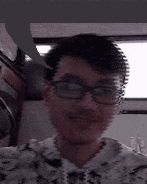 a man wearing glasses and a shirt that says ' a ' on it