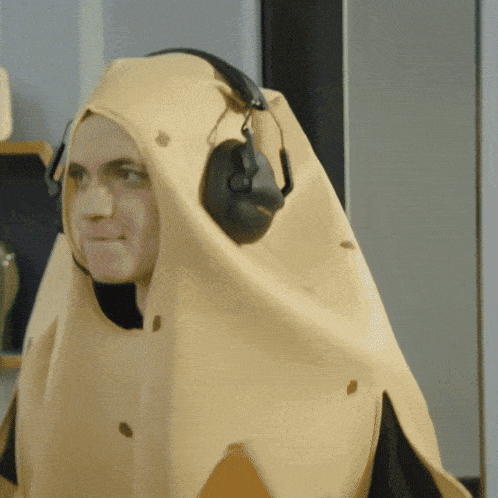 a man wearing headphones and a cape with holes in it