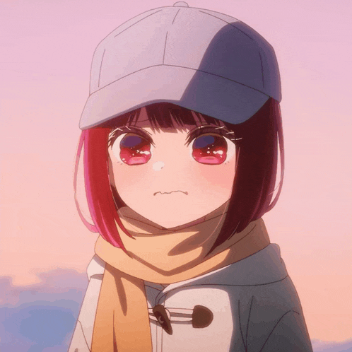 a girl with red hair wearing a hat and scarf makes a funny face