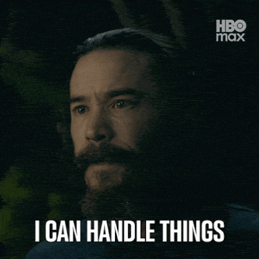 a man with a beard says " i can handle things " in a dark room