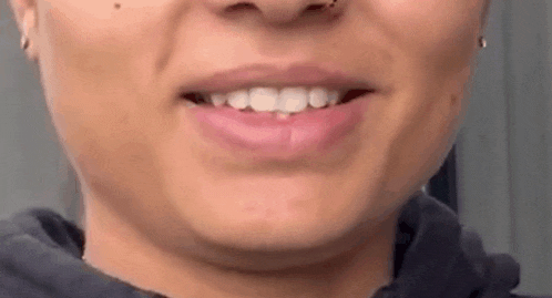 a close up of a woman 's mouth with her mouth open and her teeth showing .