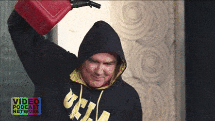 a man in a black hoodie is holding a red gas can over his head while wearing a video podcast network sweatshirt