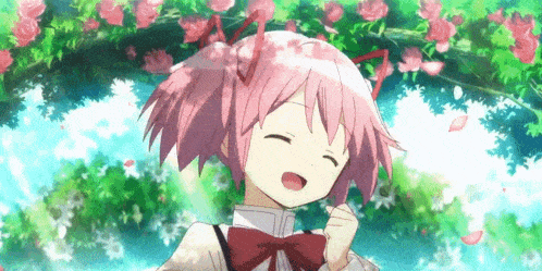 a girl with pink hair and a bow tie is smiling in front of flowers