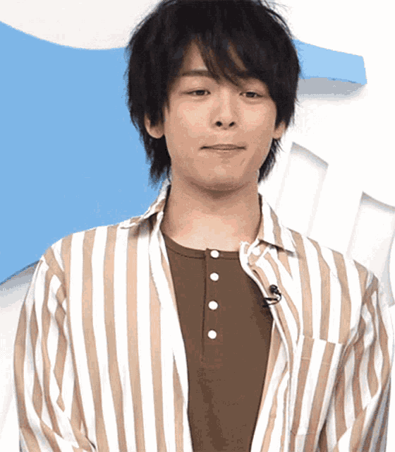 a man wearing a striped shirt with buttons on the front