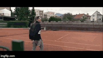 a man is playing tennis on a court with a sign that says ' gartensport ' on it