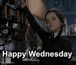 a girl in a black sweater is holding a telephone with the words `` happy wednesday '' written on it .