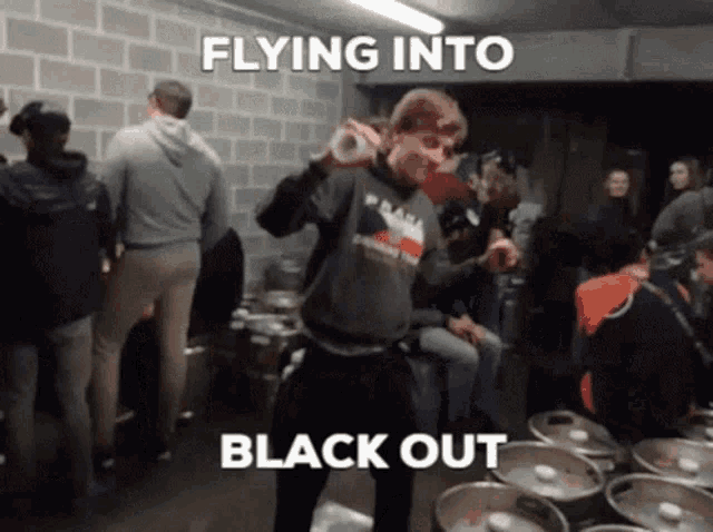 a group of people are gathered in a room with the words flying into black out