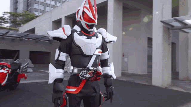 a man in a costume with a red and white helmet is standing in front of a building