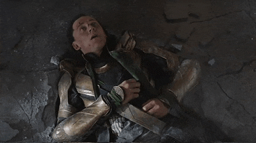 a man in a superhero costume laying on the ground