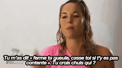 a woman in a pink shirt is talking to someone in a foreign language .