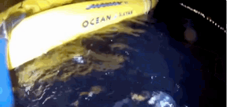 a yellow item that says ocean on it is floating in the water