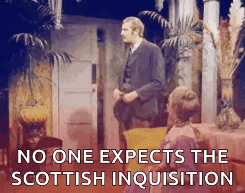 a man in a suit is standing in front of a woman in a pink dress and says no one expects the scottish inquisition