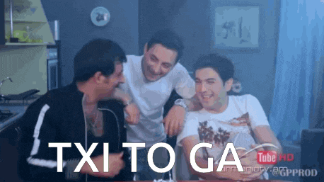 three men are sitting at a table with the words txa to ga written on the screen
