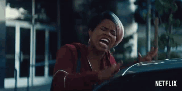 a woman is screaming while sitting in a car with a netflix logo behind her