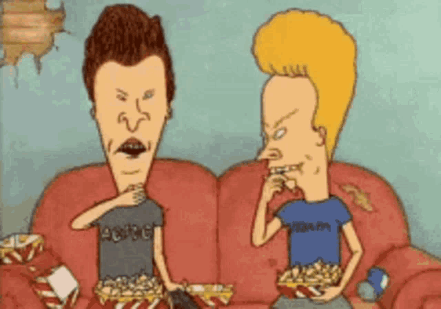 two beavis and butthead characters are eating popcorn on a couch
