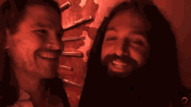 a man with a beard is smiling next to another man with the caption " this is like disney to me ok ? "