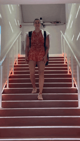 a woman is walking up a set of stairs