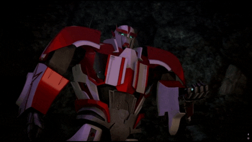 a red and white robot with a green eye