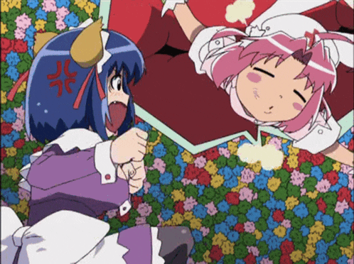 a girl with horns is laying on a bed with flowers and a girl with pink hair is laying on a bed with flowers