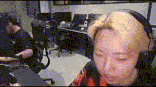 a man wearing headphones is sitting at a desk in front of a computer .