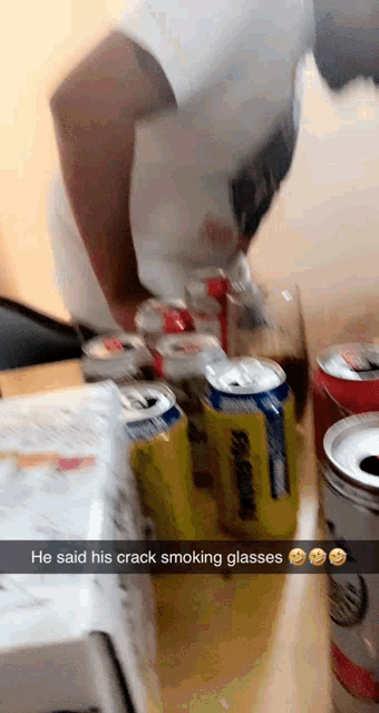 a man is standing in front of a stack of soda cans with a caption that reads he said his crack smoking glasses