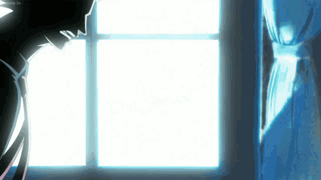 a person is standing in front of a window and looking out .