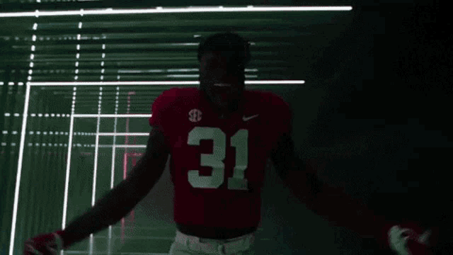 a man wearing a red jersey with the number 31 on it
