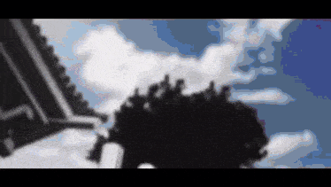 a black and white drawing of a cloudy sky with trees in the foreground