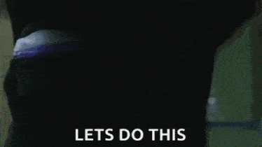 a man in a black jacket and white collar is holding a card and saying `` let 's do this '' .