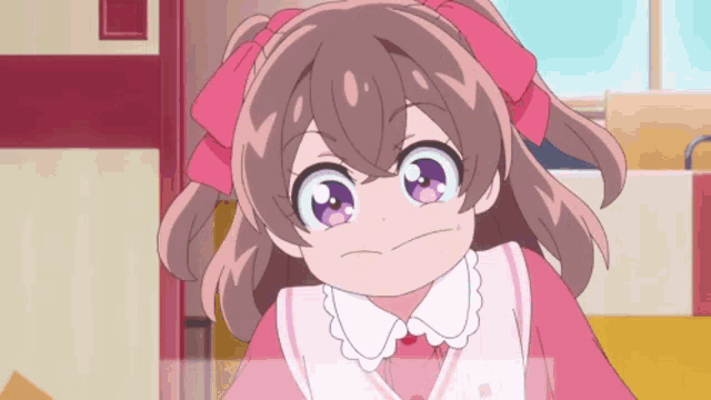 a little girl with a pink bow in her hair is making a funny face .