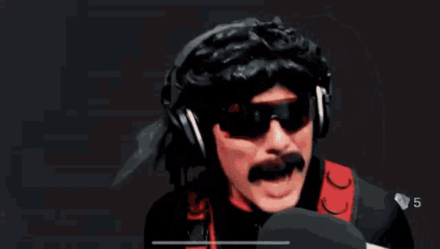 a man with a mustache and sunglasses is wearing headphones and a wig .