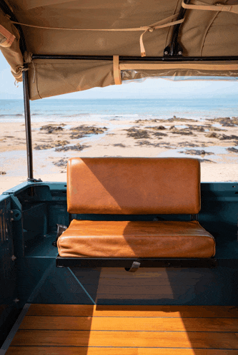 the back seat of a vehicle with a view of a beach