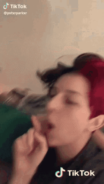 a tiktok video of a woman with red hair making a silly face