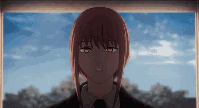 a girl with red hair and orange eyes is looking out a window