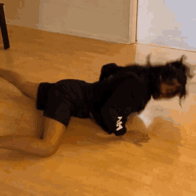 a person laying on the floor with a sweatshirt that says nm on the arm
