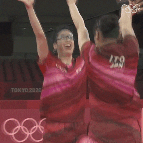 a man and a woman are playing ping pong in tokyo 2020