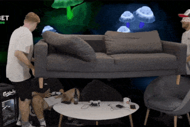 a carlsberg cooler sits behind a couch