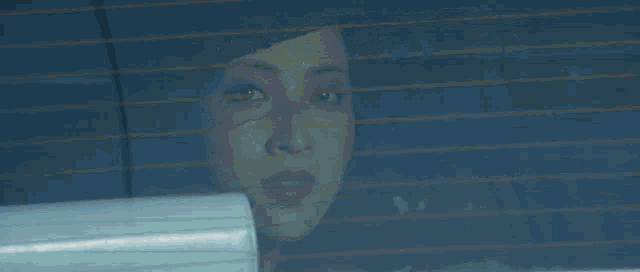 a person sitting in a car with a rear view mirror
