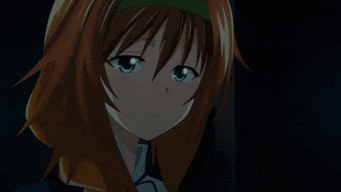 a girl with brown hair and blue eyes is looking down in the dark