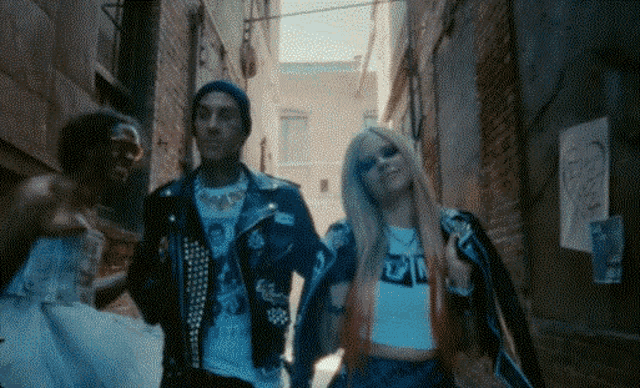 a man and a woman are standing in an alleyway .