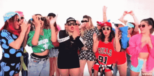 a group of women wearing bulls jerseys are dancing together