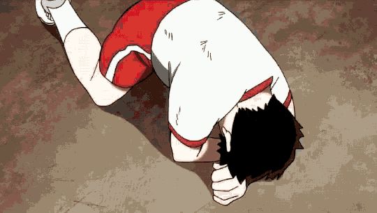 a man is laying on the ground with his head on his hands