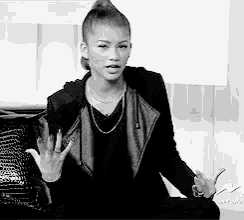 a black and white photo of a woman in a black jacket