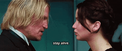 a man and a woman are looking at each other and the man is saying `` stay alive . ''