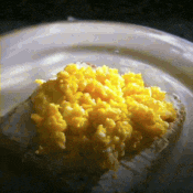 a close up of a plate of food with yellow rice