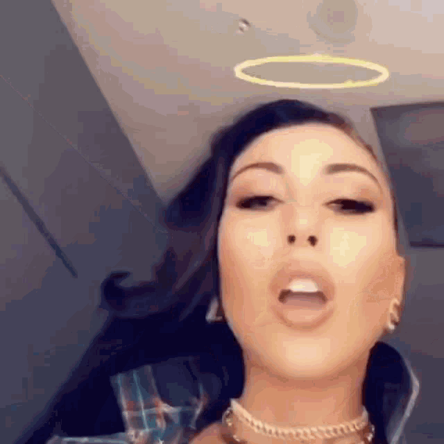 a close up of a woman with a halo around her head .