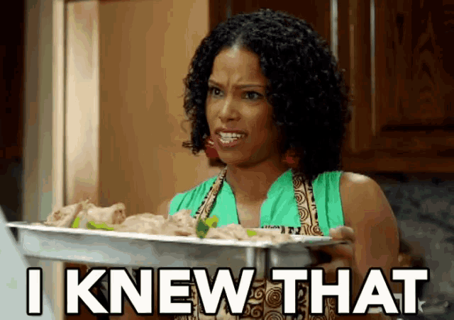 a woman holding a tray of food with the words " i knew that " below her