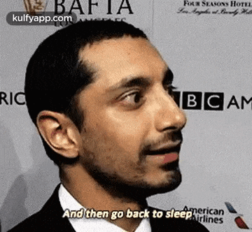 a close up of a man 's face with the words `` and then go back to sleep '' written on it .
